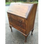 An Edwardian mahogany bureau, the crossbanded fallfront enclosing an interior with small drawer