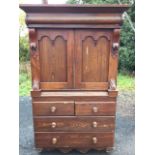 A Victorian ash press cupboard, the top with angled cornice above a split column frieze, having twin