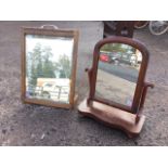 A Victorian mahogany dressing table mirror with arched plate in cushion moulded frame on scrolled