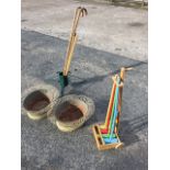 A pair of oval wirework basket plant pots with tin liners; a Christmas tree stand; a childs