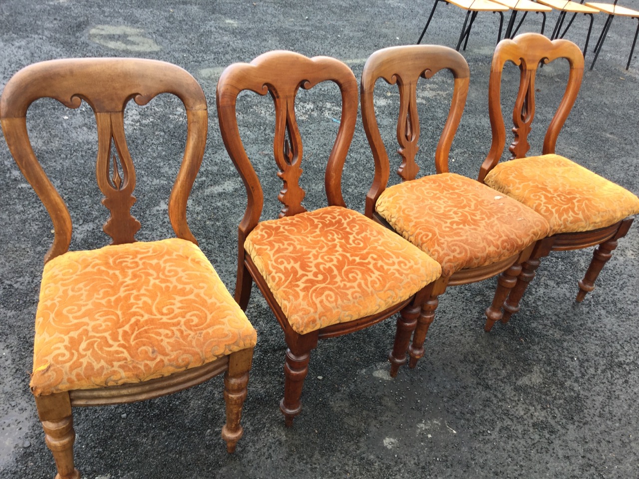 A married set of four Victorian mahogany dining chairs, the scroll carved backs above pierced