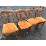 A married set of four Victorian mahogany dining chairs, the scroll carved backs above pierced