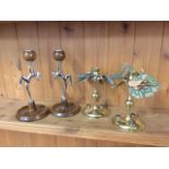 A pair of unusual Victorian brass candlesticks, with urn shaped candleholders on columns, the