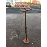 A Victorian mahogany music stand with later alterations, the ratchet adjustable column beneath