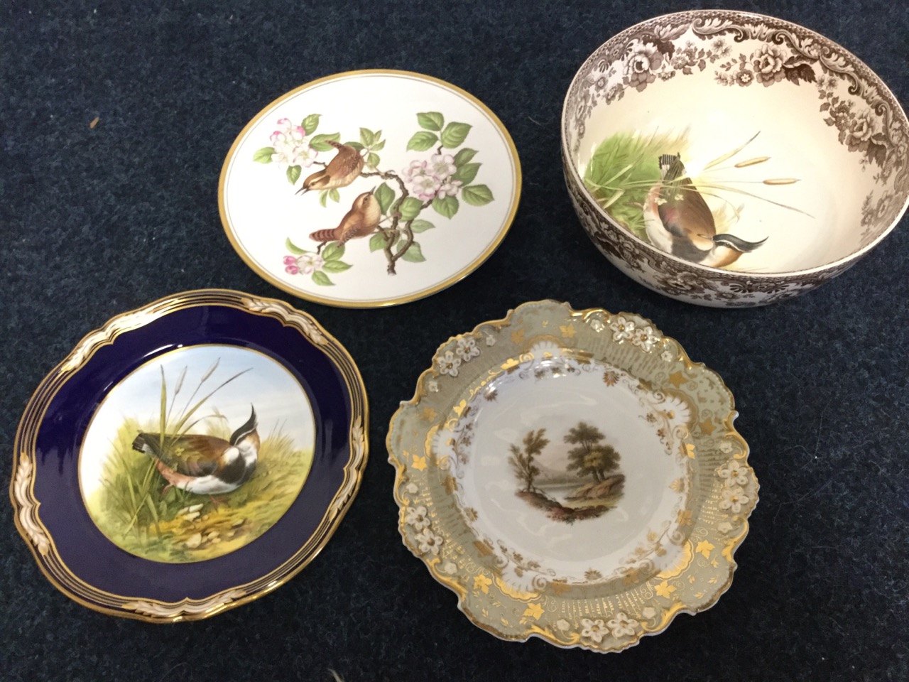 A nineteenth century Davenport plate painted with a country river landscape scene, with floral
