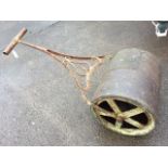A Victorian cast iron garden roller with scrolled decoration to handle, the drum with chanelled