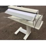A Míele B895D ironing machine with heated roller on stand with casters. (38.5in x 37.5in)