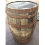 A 3ft oak whiskey barrel, the staves bound by six metal strap bands. (35in)