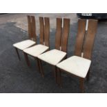 A set of four contemporary oak dining chairs, the shaped backs with twin splats above upholstered