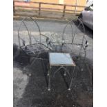 A pair of gothic style heavy wrought iron garden chairs, with a matching square glass topped