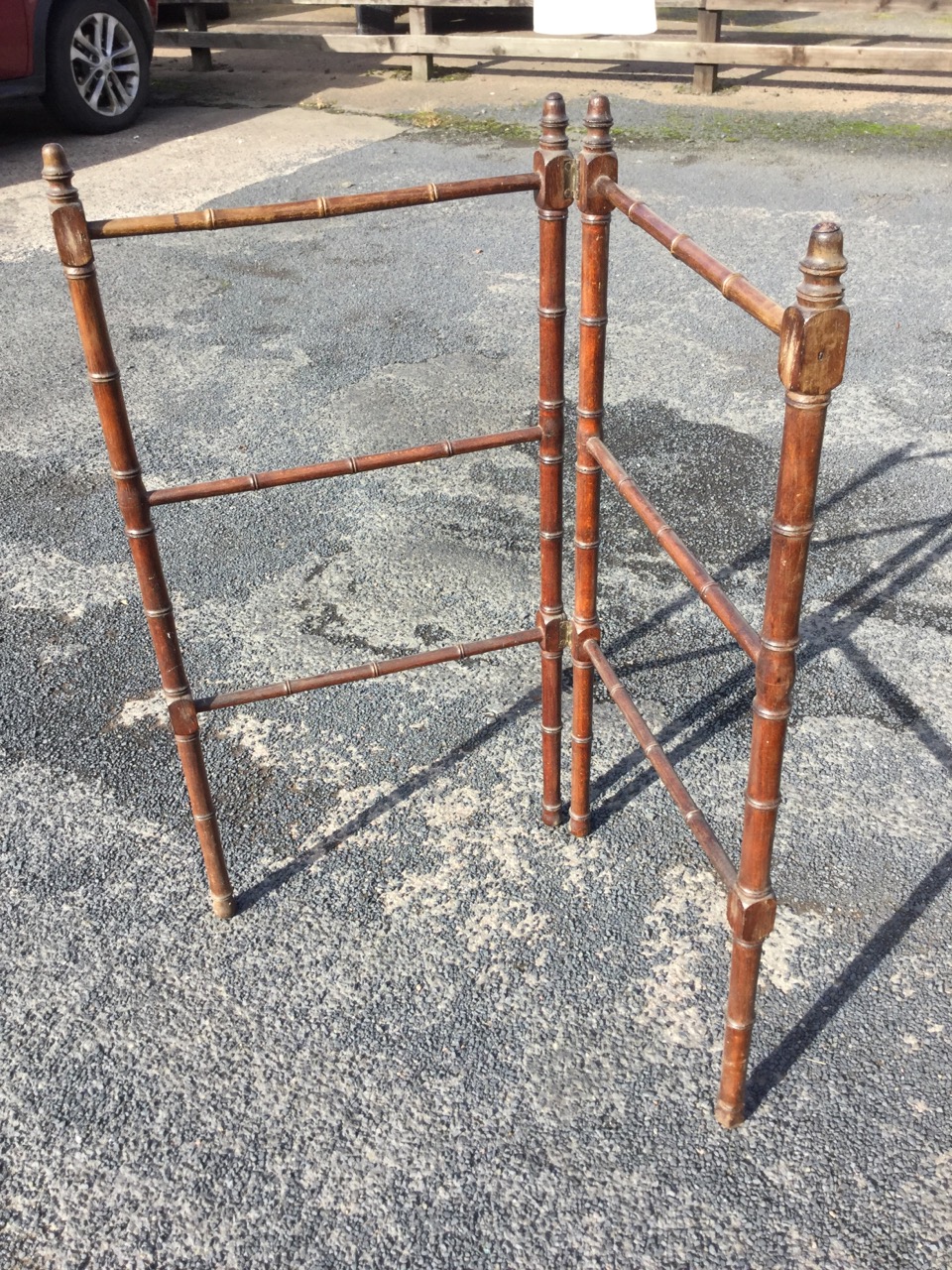 A Victorian two-fold mahogany towel stand with bamboo turned rails on ring-turned columns, having