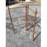 A Victorian two-fold mahogany towel stand with bamboo turned rails on ring-turned columns, having