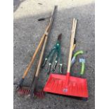 Miscellaneous garden tools including a yard brush, a rake, two snow shovels, two trowels, a loper,