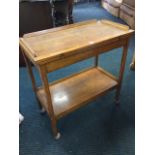 An oak desk, the rectangular panelled top with small gallery having turnover action with brass