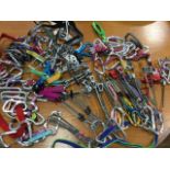 A quantity of modern climbing gear - friends, karabiners, nuts, slings, belay devices, screwgates, a