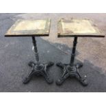 A pair of cast iron table bases with fluted tapering columns on quadripartite pierced legs with