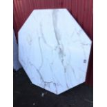 An octagonal marble table top, the slab on wood base. (51in dia)
