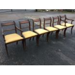 A set of six regency style mahogany dining chairs with two carvers, the reeded backs with twisted