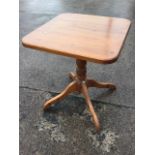 A square pine occasional table, the rounded top on turned column with quadripartite shaped legs. (