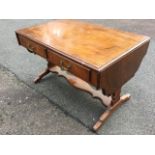 A mahogany sofa table with scalloped drop ends, the crossbanded top above two frieze drawers on