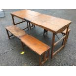 A rectangular Edwardian pine campaign table and two benches by W Thrornhill & Co, the folding