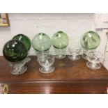 Eight cut glass dessert glasses with saucer bases; and five green glass fishing net floats. (13)
