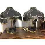 A pair of brass tablelamps with square black beaded shades above black & gilt glazed porcelain