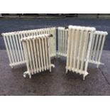 A pair of freestanding rectangular cast iron radiators - 38in; another with moulded ribs - 17.5in;