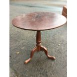 A Georgian circular mahogany snap-top table, the top on pegged box birdcage above a barrel turned