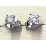 A pair of 18ct white gold diamond stud earrings, the claw set diamonds of under half a carat, fitted