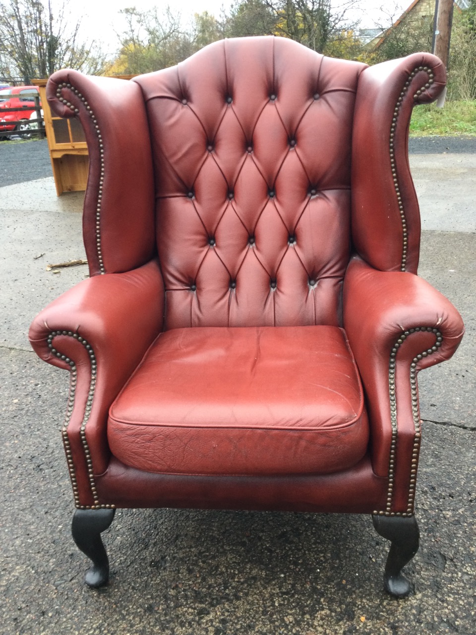 A Queen Anne style button upholstered wing armchair with brass studding, raised on cabriole legs. - Image 2 of 3