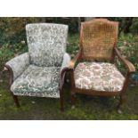 A walnut armchair with shaped cane back above tapering arms and sprung seat with loose cushion,
