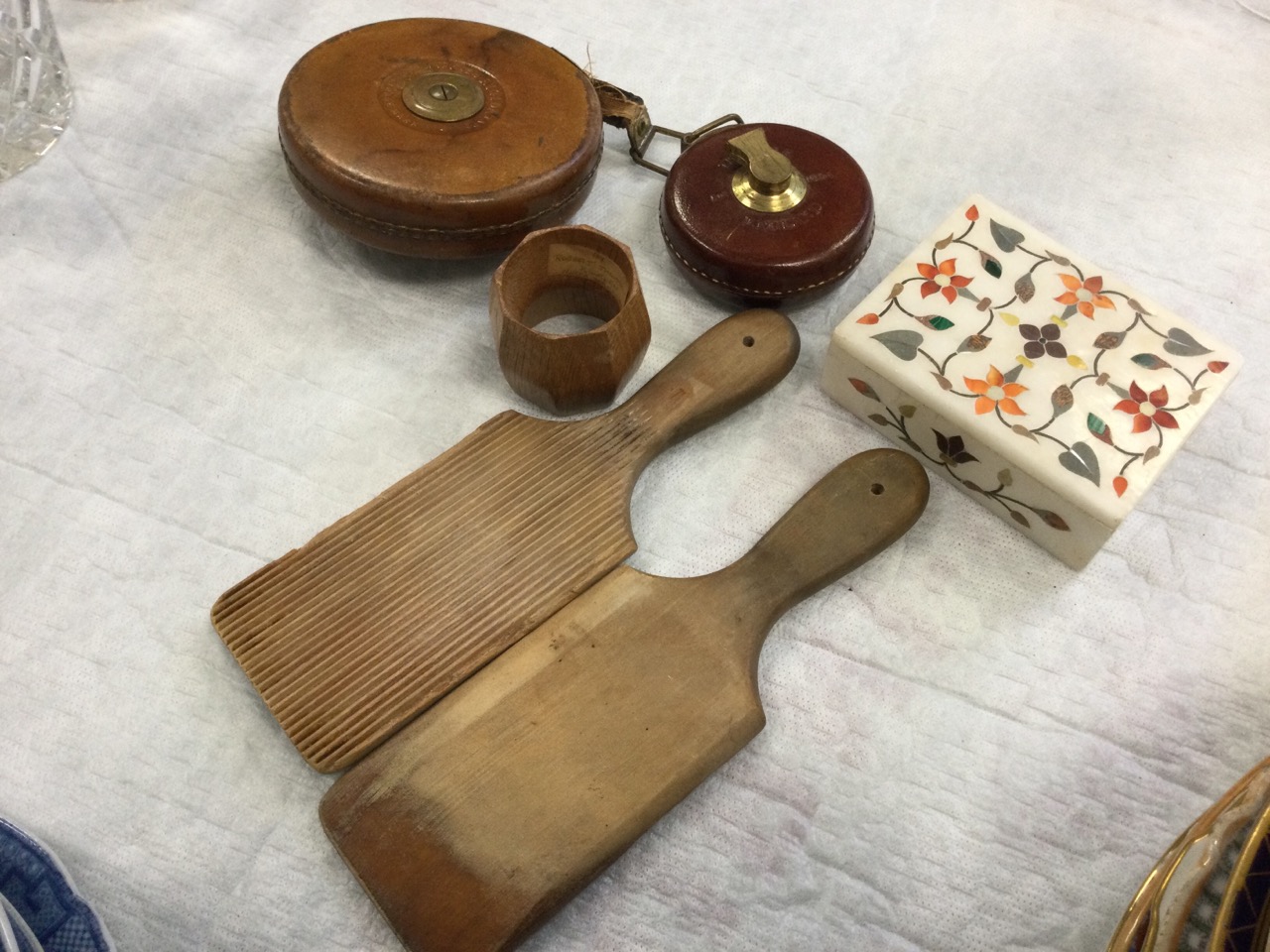 A mouseman carved oak octagonal napkin ring; a pair of ribbed butterpats; two leather cased tape