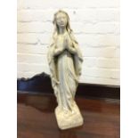 A faux marble figure of a praying lady, modelled with rosary to arm standing on square plinth