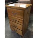A small pine chest of four long drawers mounted with brass swan-neck handles. (17.75in x 14in x