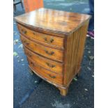 A small nineteenth century bowfronted chest of drawers, the top with reeded edge above four