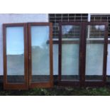 Two pairs of hardwood doors, each with rectangular double glazed panels in moulded frames, and