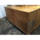 An oak arts & crafts style dresser, with rectangular top above a bank of four central drawers framed
