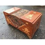 A Chinese carved camphorwood chest, the arched central section profusely carved with battle scenes