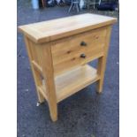 A modern oak side cabinet, the cleated top above a brass knobbed deep drawer modelled as two, raised