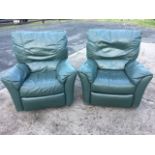 A pair of contemporary leather armchairs with panelled cushions above sprung seats, each having