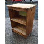 A pine open shelf cabinet with rectangular rounded top above a shaped apron with pierced trefoil,