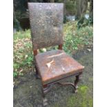 An embossed leather Queen Anne style walnut hall chair, the padded back with armorial style panel of