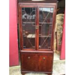 An illuminated mahogany corner display cabinet, with moulded cornice above astragel glazed doors