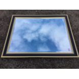 A contemporary rectangular mirror, the bevelled plate in ebonised frame with gilded borders, the