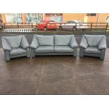 A modern grey leather three-piece suite with padded arms and loose cushion seats, a pair of