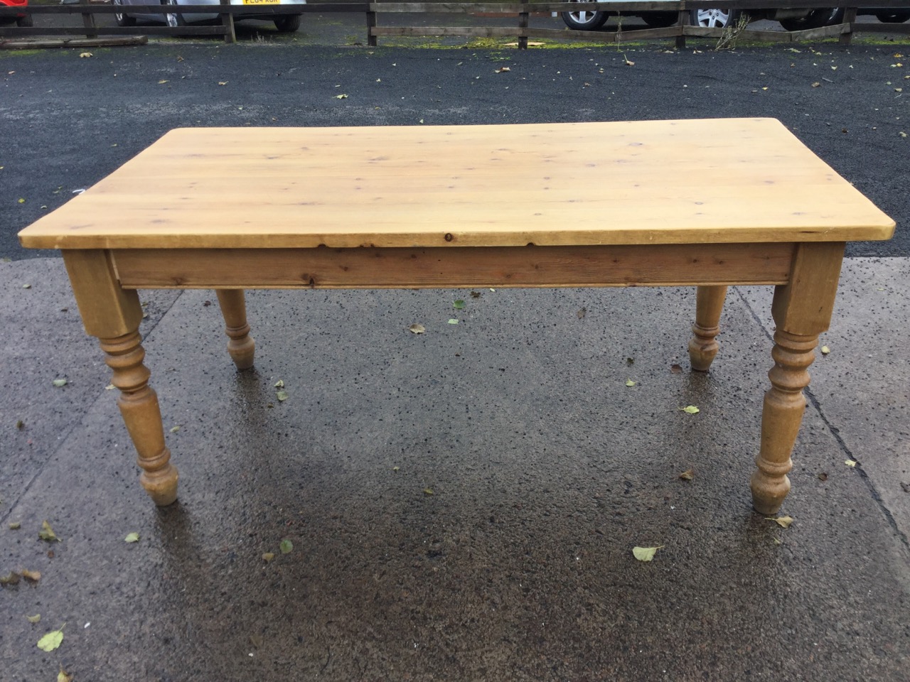 A pine kitchen table, the rectangular thick plank top on turned legs. (70.5in x 35.5in x 30.75in) - Image 2 of 3