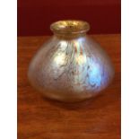 A Loetz style iridescent art glass vase, with flared rim and tapering bowl, raised on moulded foot