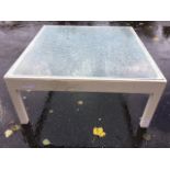 A large painted coffee table with plate glass top on square chamfered column legs. (37in x 35in x