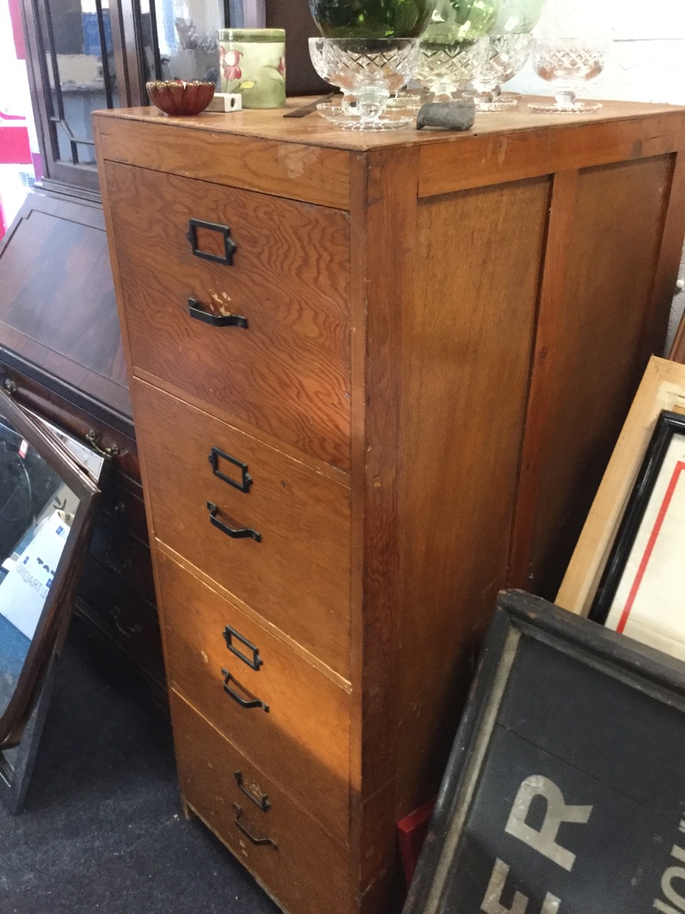 A large wood filing cabinet, the four drawers mounted with metal handles and label holders. (20in - Image 2 of 3